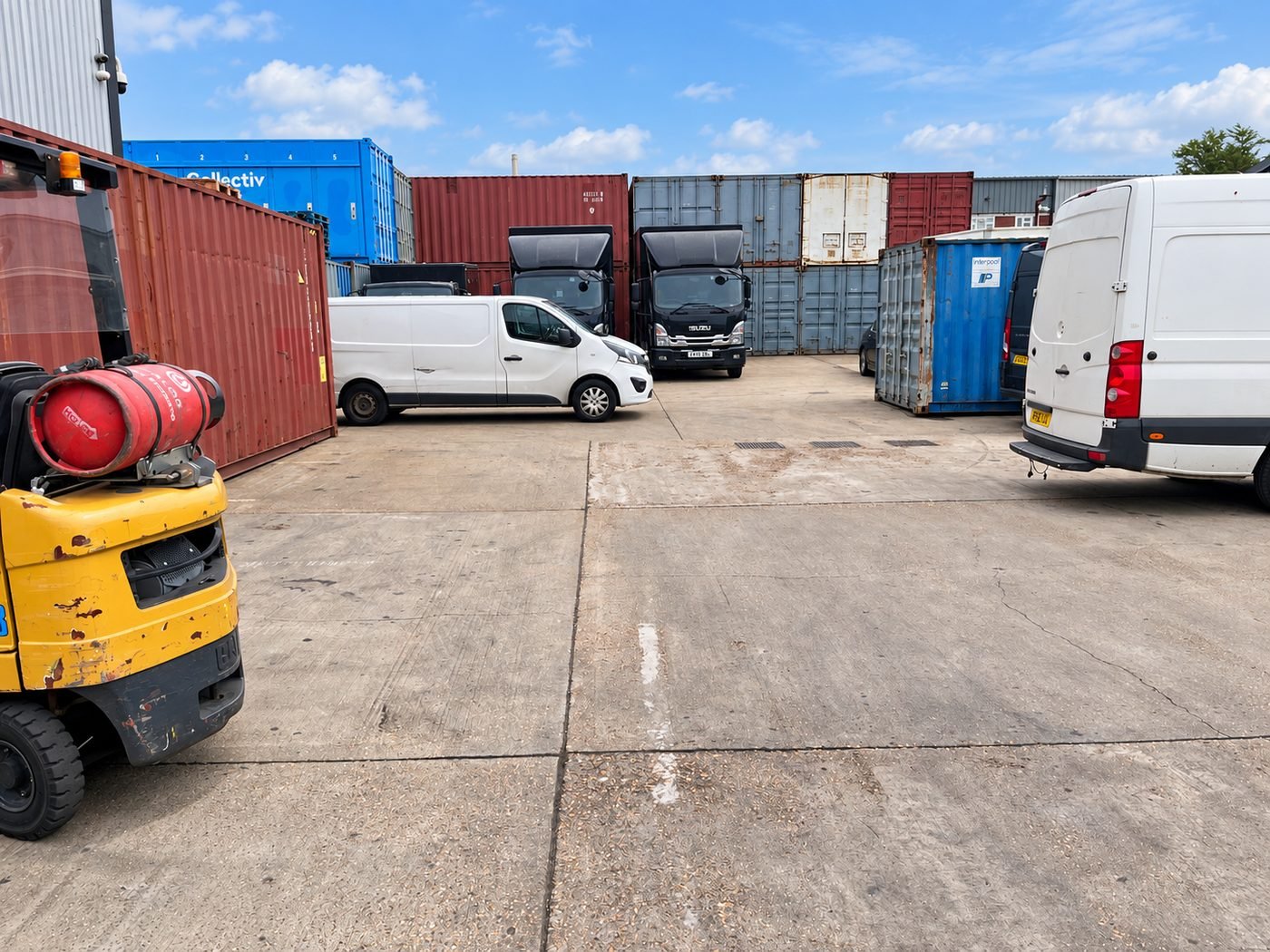 Vans and a forklift on the open concrete yard at Double 4 Ltd